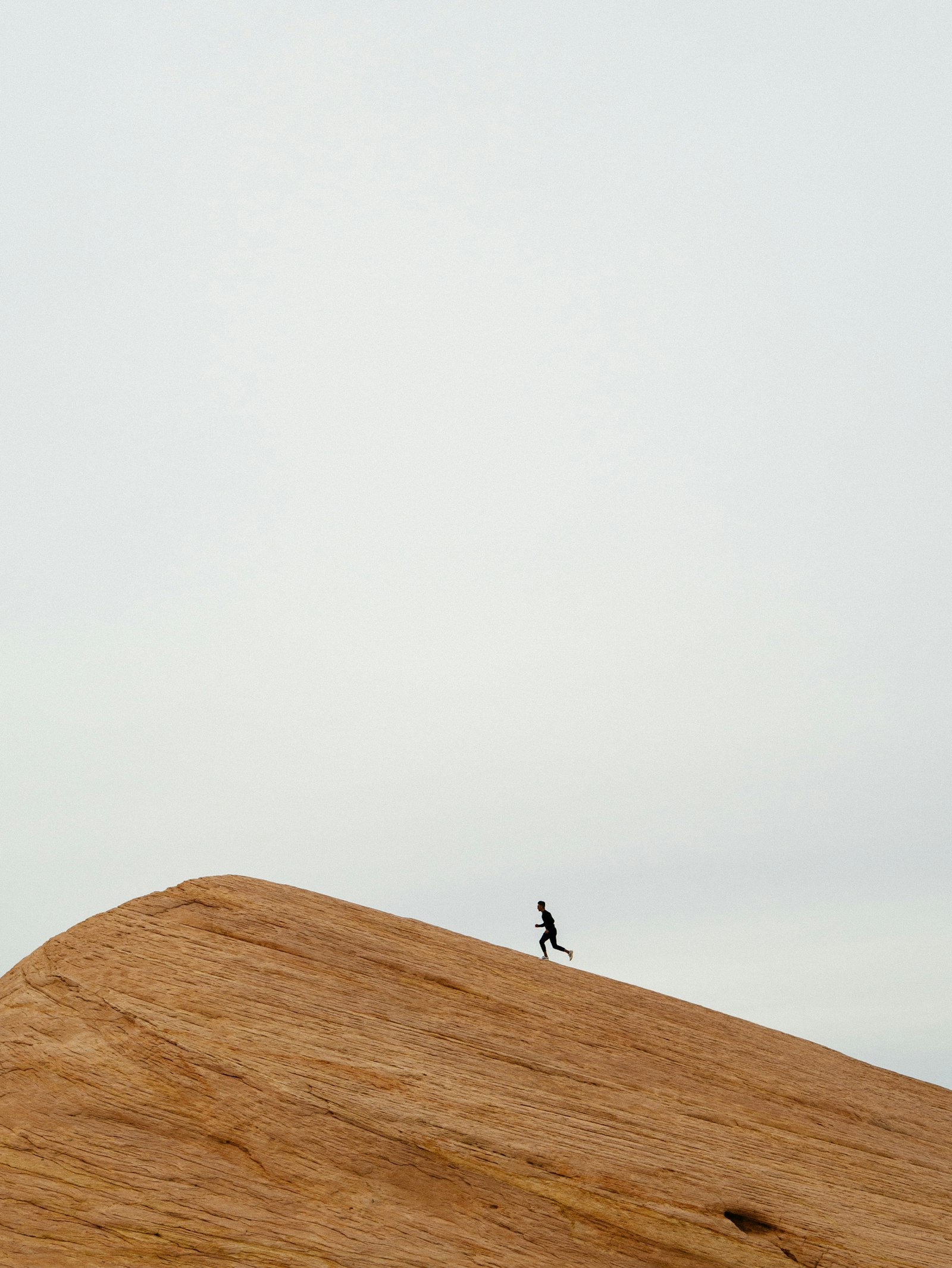Runner cresting a ridge